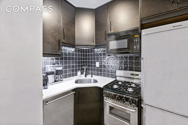 kitchen featuring a sink, stainless steel appliances, tasteful backsplash, and dark brown cabinets