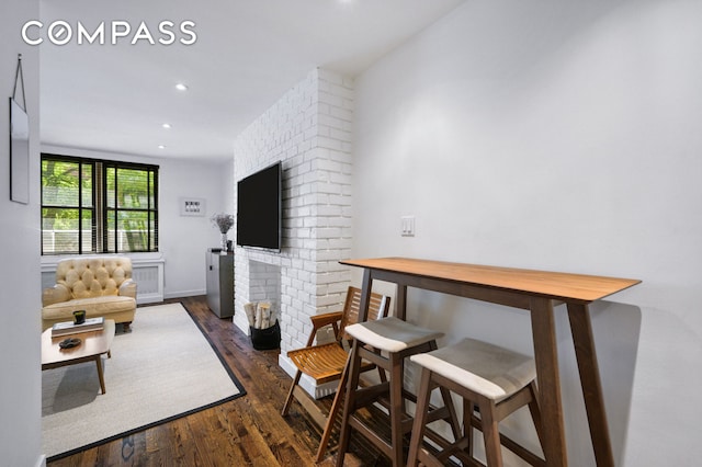 living area with a fireplace, recessed lighting, and dark wood-style floors