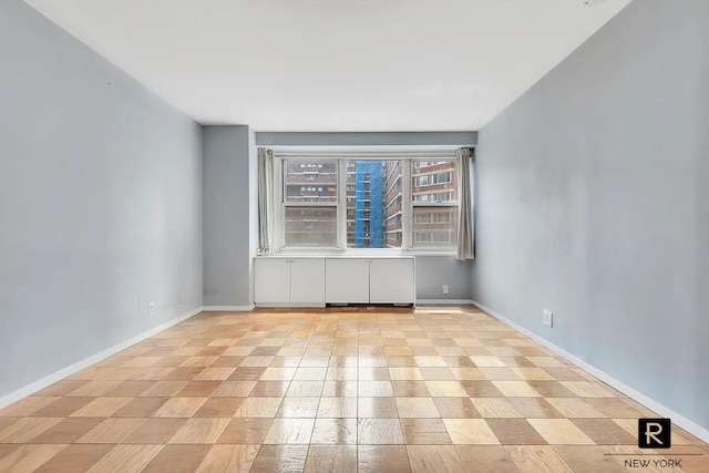 empty room featuring baseboards