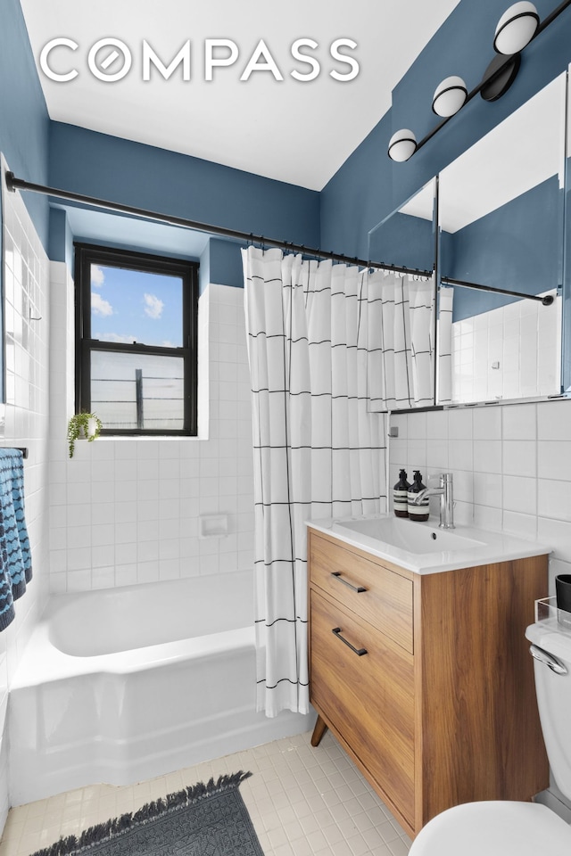 full bathroom featuring vanity, tile patterned flooring, tile walls, toilet, and shower / tub combo with curtain