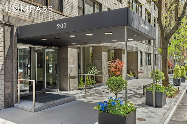 entrance to property featuring brick siding