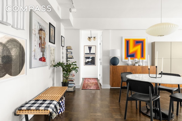 dining area with rail lighting and baseboards