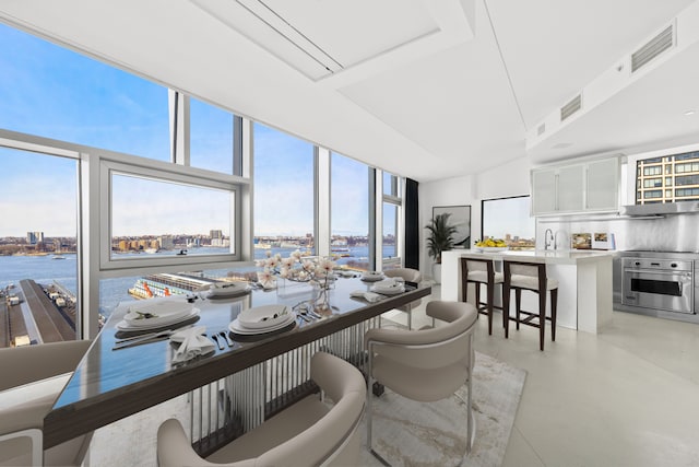 dining room featuring a view of city, visible vents, concrete flooring, and expansive windows