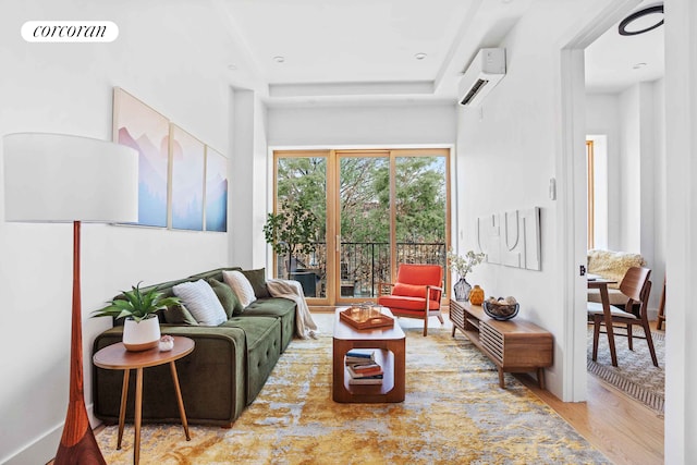 living area with an AC wall unit, wood finished floors, and visible vents