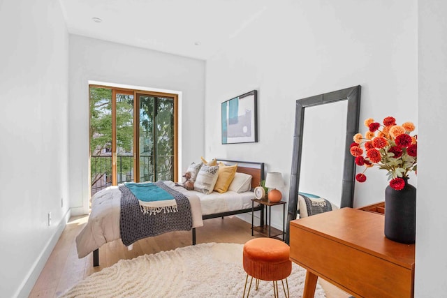 bedroom featuring baseboards and wood finished floors