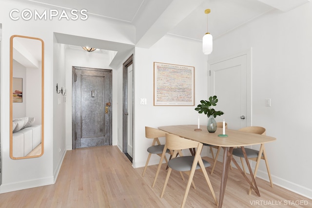 dining room featuring baseboards and light wood-style floors