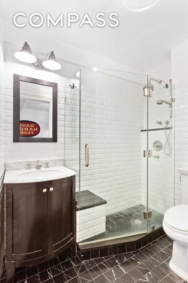 227 E 57th St Unit 8Efg, New York City, NY 10022 - full bath featuring toilet, vanity, a stall shower, and marble look tile flooring