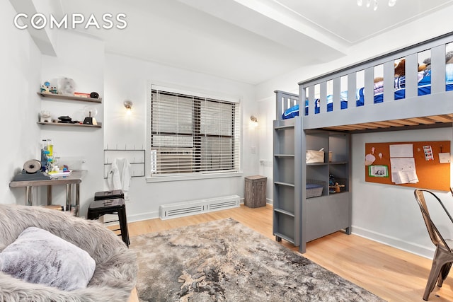 bedroom with wood finished floors and baseboards