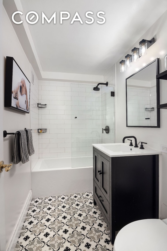 bathroom featuring tile patterned floors, toilet, vanity, and shower / bathing tub combination