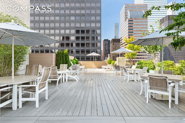 deck featuring a city view and outdoor dining space