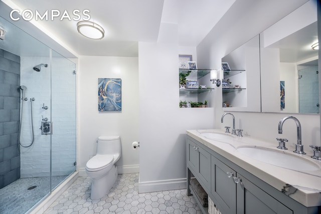 full bath with baseboards, a tile shower, and a sink