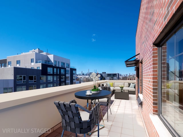 balcony with a view of city and an outdoor hangout area