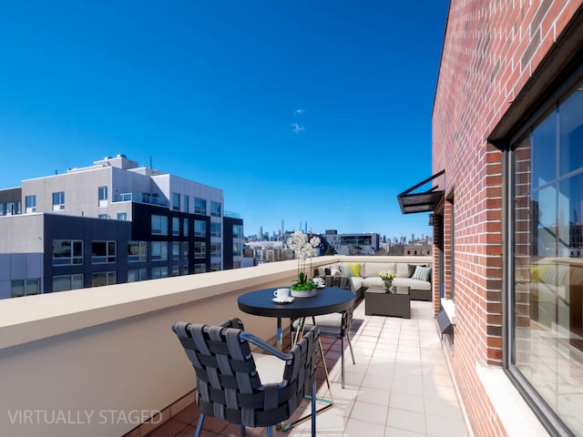 balcony with a view of city and an outdoor hangout area