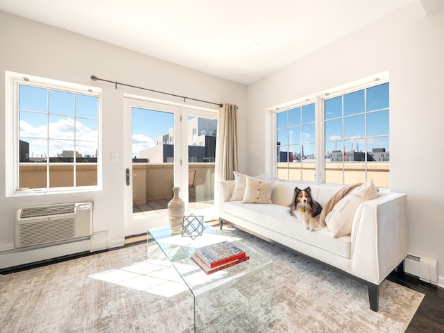 32-86 41st St Unit 5C, New York City, NY 11103 - living room featuring a wall mounted AC, a baseboard heating unit, baseboards, and wood finished floors