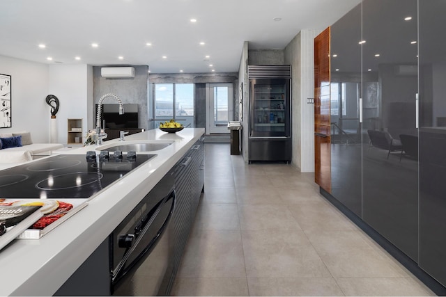 kitchen with a wall mounted AC, recessed lighting, built in fridge, modern cabinets, and open floor plan