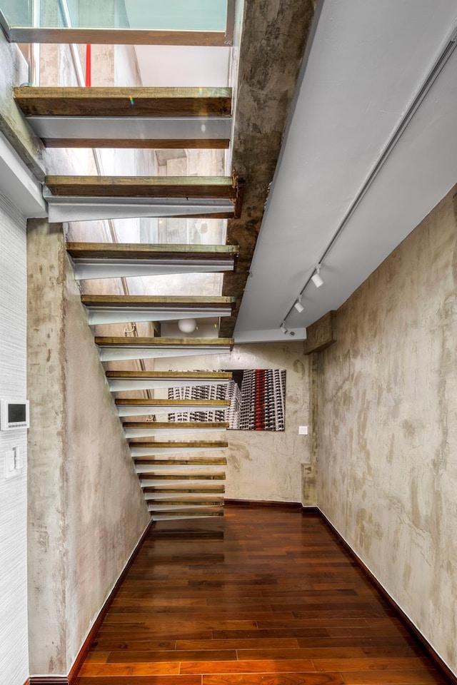 interior space featuring track lighting and hardwood / wood-style flooring