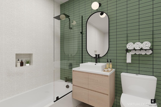 bathroom featuring vanity, tile walls, toilet, and  shower combination