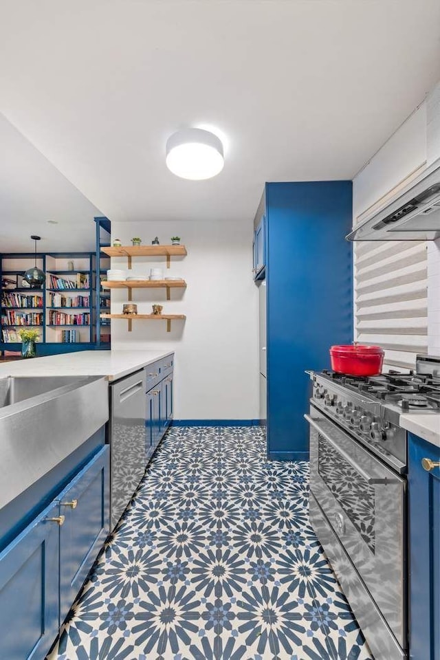 kitchen featuring light countertops, tile patterned floors, stainless steel appliances, blue cabinets, and open shelves