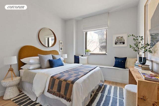 bedroom featuring wood finished floors and visible vents