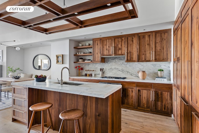 kitchen featuring a sink, open shelves, a kitchen breakfast bar, coffered ceiling, and tasteful backsplash