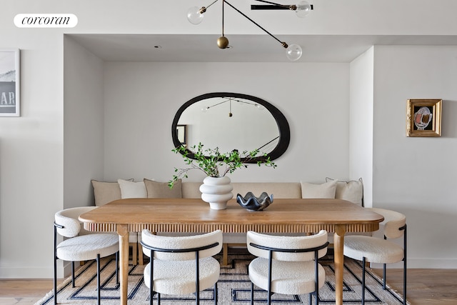 dining room featuring light wood-style floors, visible vents, and baseboards