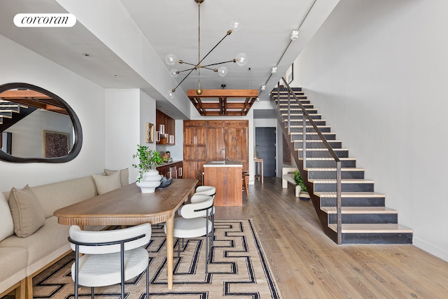 dining area with stairway, a notable chandelier, visible vents, and light wood-type flooring