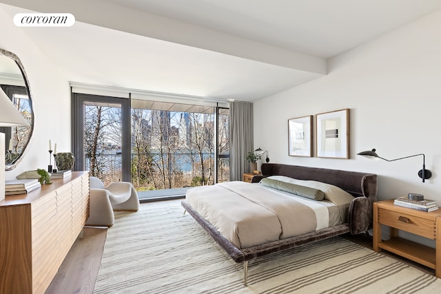 bedroom featuring access to outside, wood finished floors, and visible vents