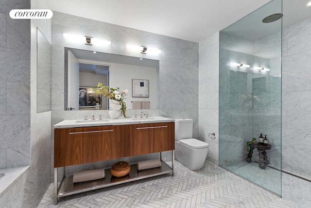 full bathroom featuring double vanity, toilet, tile walls, and a sink