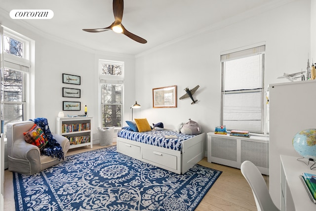 bedroom with crown molding, multiple windows, radiator heating unit, and visible vents