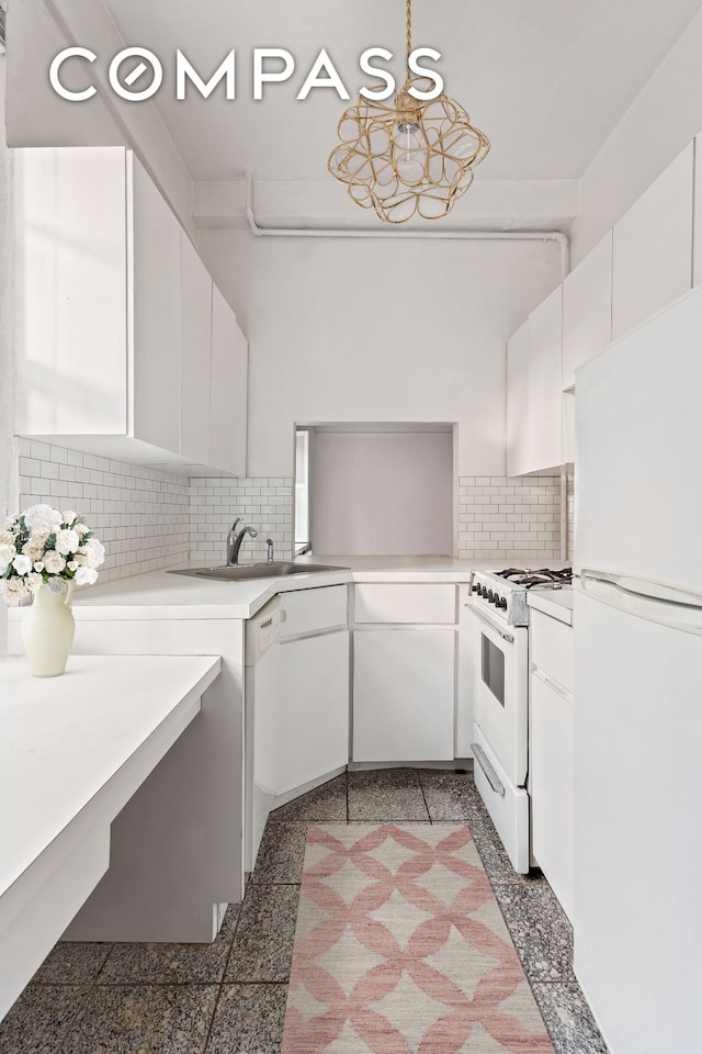 kitchen with granite finish floor, white cabinets, light countertops, and white appliances