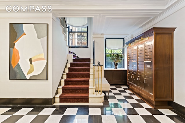 staircase with tile patterned floors, mail area, and ornamental molding