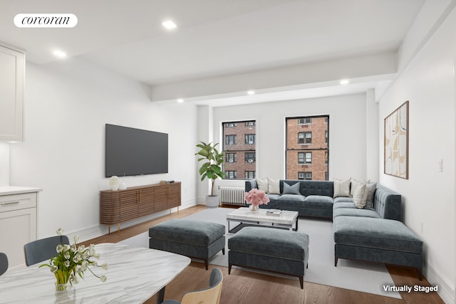 living area with recessed lighting, visible vents, and wood finished floors