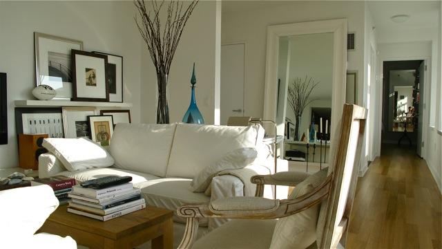 living area with visible vents and wood finished floors