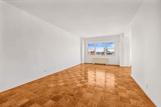 unfurnished room with baseboards