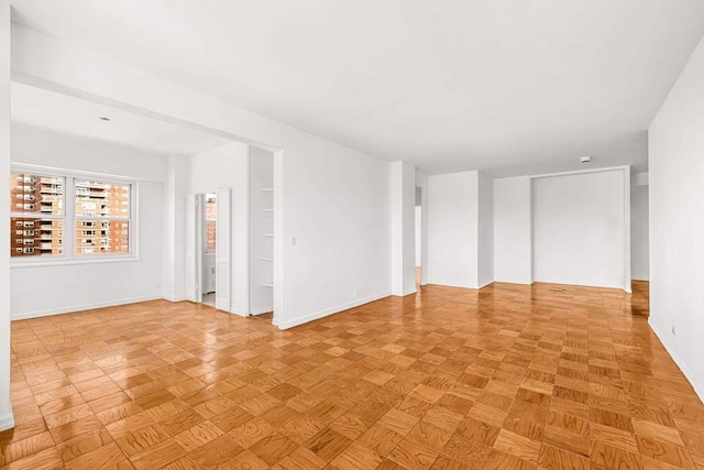 spare room featuring baseboards