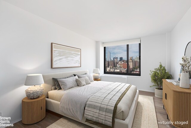 270 W 17th St Unit 14B, New York City, NY 10011 - bedroom featuring wood finished floors and baseboards