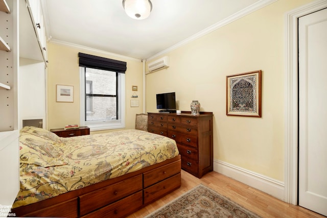 bedroom with light wood-type flooring, baseboards, an AC wall unit, and crown molding