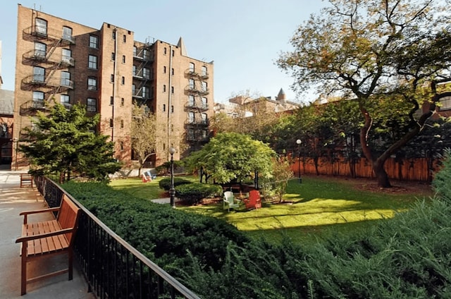 surrounding community featuring a lawn and fence