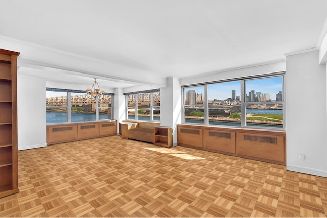 unfurnished sunroom with a view of city, a water view, and a chandelier