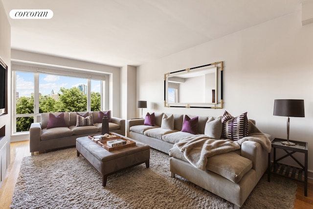 living room featuring visible vents and wood finished floors