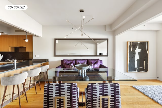 dining space with wood finished floors and visible vents