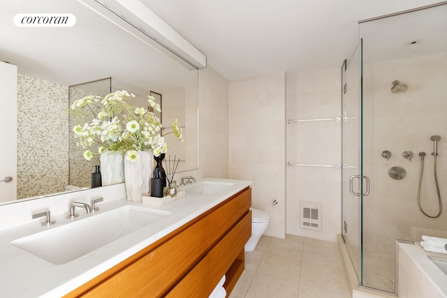 1280 5th Ave Unit 7/A, New York City, NY 10029 - bathroom featuring a shower stall, tile patterned flooring, toilet, and double vanity