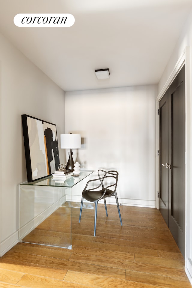 office space with light wood-style floors and baseboards