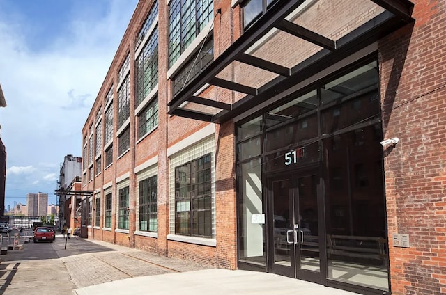 property entrance featuring brick siding