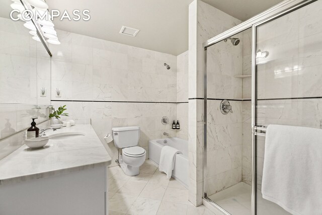 bathroom with visible vents, toilet, a stall shower, a bathtub, and vanity