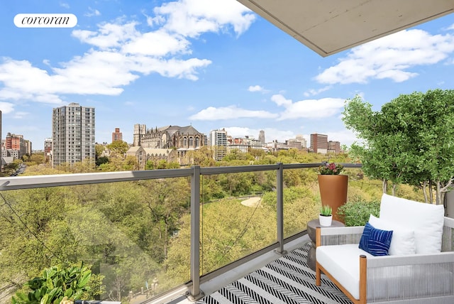 balcony with an outdoor living space and a view of city