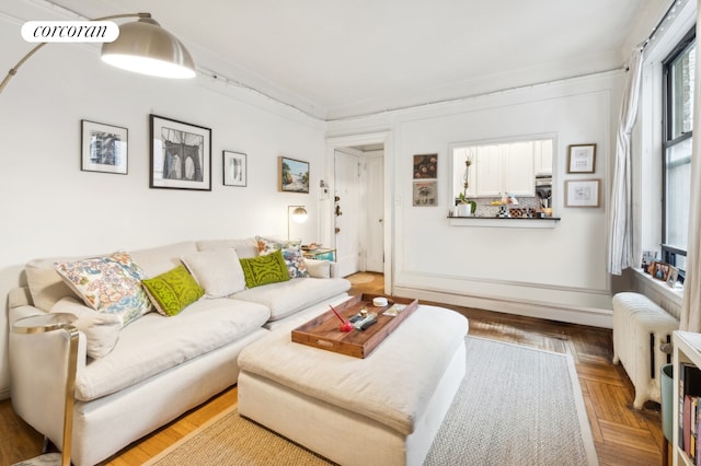 living room featuring visible vents, crown molding, and radiator heating unit