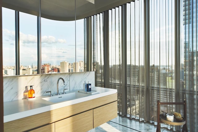 bathroom featuring a city view, plenty of natural light, and vanity