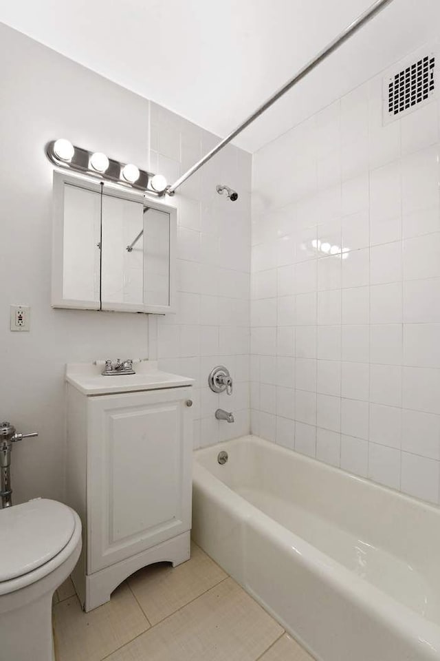 bathroom featuring visible vents, toilet, washtub / shower combination, tile patterned flooring, and vanity