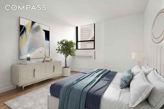 bedroom featuring baseboards and wood finished floors